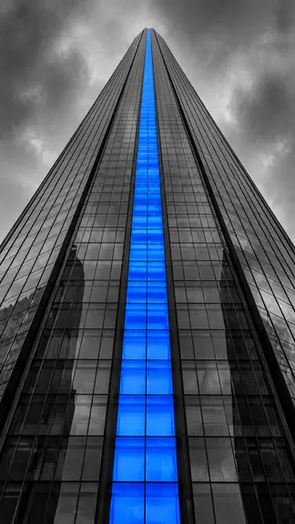 Looking up a glass skyscraper with one blue column of windows