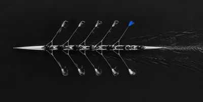 Rowing eight from above, one blue oar