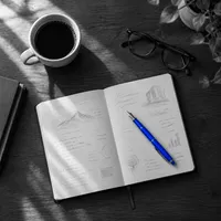 Notebook and coffee with a blue pen